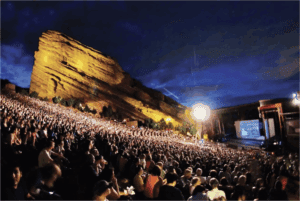 picture of Red Rocks concert venue full with people watching movie.