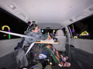 Mikelle watching the Christmas lights from her van.
